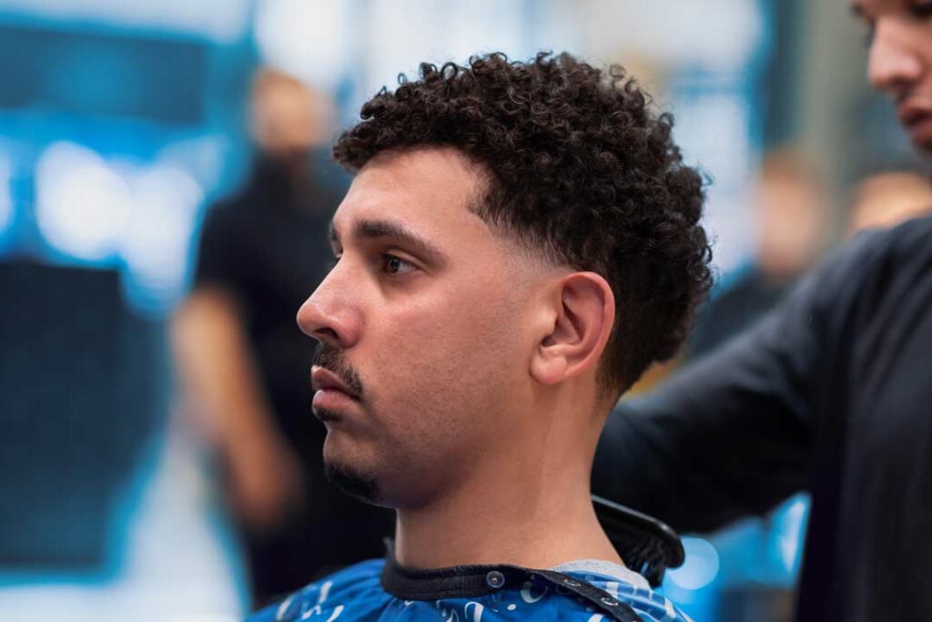 14 Fresh Haircut Ideas for Men with Curly Hair: Elevate Your Look with Texture and Style 2 64a8ae63a43224831fcd11ad Low Taper Fade Blowout