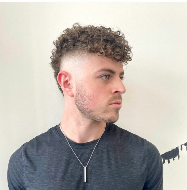 20 Stylish Hispanic Hairstyles for Men: A Complete Grooming Guide 15 Curly Mohawk Fade Hairstyle 650x659 1