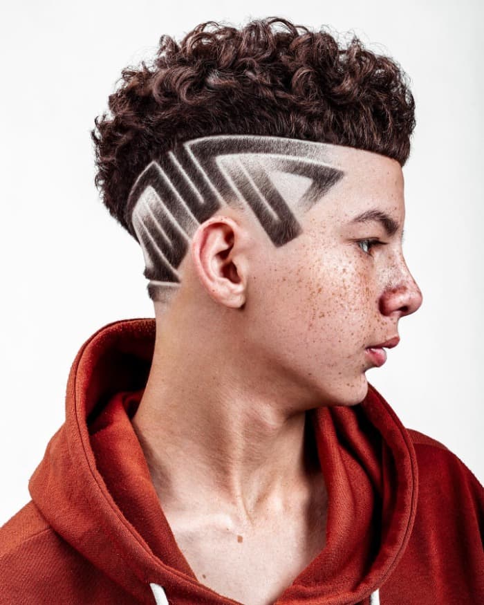 10 Athletic Red Hairstyles: High-Performance Looks with Fiery Style 6 Undercut Haircut Design for Men with Curly Hair