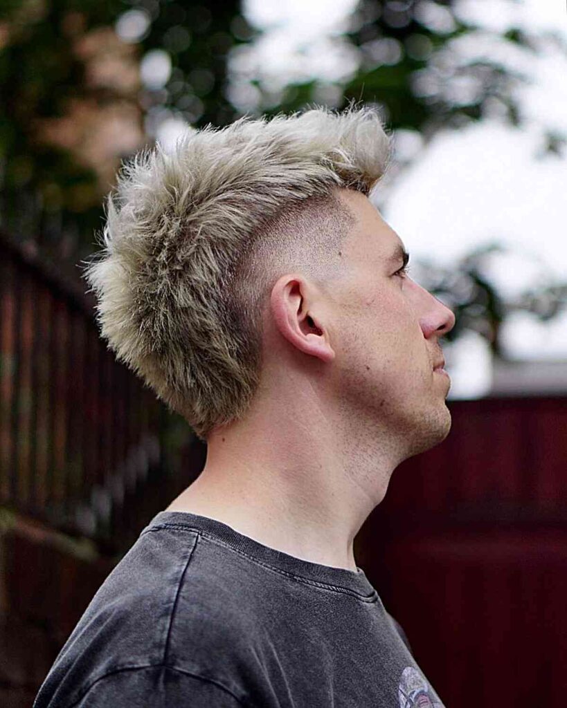 14 Stunning Twist Styles for Modern Black Men: Versatile Looks for a Confident Identity 10 mohawk fade with blonde hair coloring for men