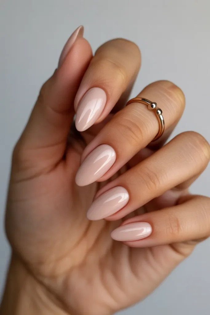 classic nude almond shaped nails with gl f4sJJSnFSM VC38iaE4P5A 2XjC3B8SSp2eWaD8cDpoGg